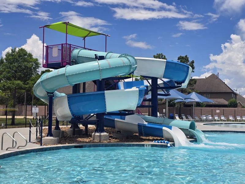 Colorful water slide at a pool with a clear blue sky above